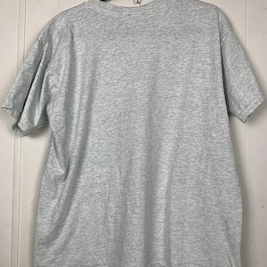 May include: A heather grey short-sleeved t-shirt. The shirt is plain with no visible graphics or text.