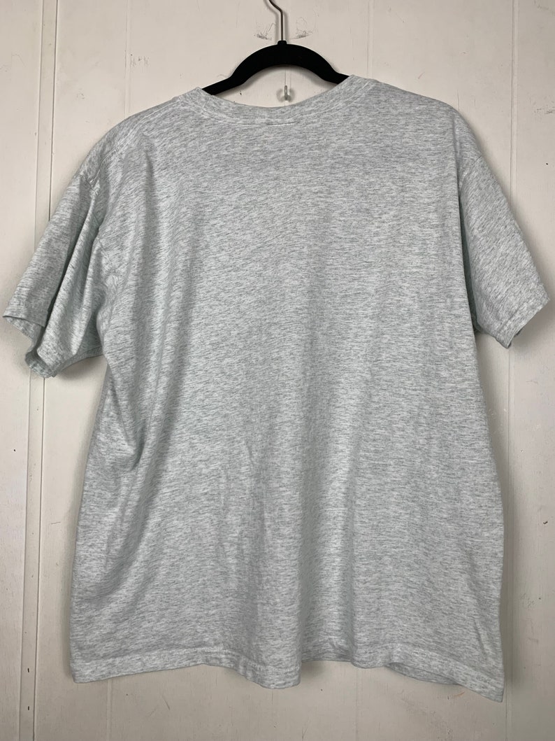 May include: A heather grey short-sleeved t-shirt. The shirt is plain with no visible graphics or text.