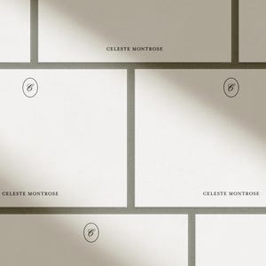 Multiple white personalized flat notecards arranged in a grid pattern with diagonal sunlight shadows across them.