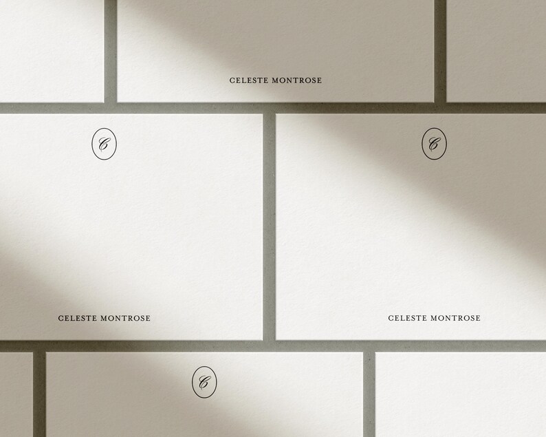 Multiple white personalized flat notecards arranged in a grid pattern with diagonal sunlight shadows across them.