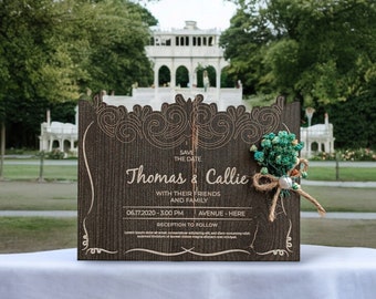 Pode incluir: Um cartão de madeira rústico com um laço de corda marrom e um pequeno buquê de flores brancas e verdes. O cartão apresenta o texto "Save the Date", "Thomas & Callie", "With their friends and family", "06.17.2020 - 3:00 PM", "Avenue - Here", e "Reception to follow".