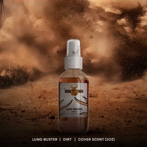 May include: A brown glass spray bottle with a white cap and label. The label says "Bugk Maxx" and "Lung Buster Dirt Cover Scent 2oz".