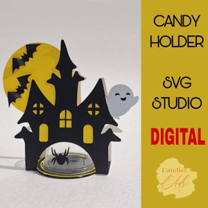 May include: A black and yellow Halloween-themed candy holder shaped like a haunted house with a ghost and bats. The holder is designed to be cut out and assembled using a digital cutting machine. The text "CANDY HOLDER SVG STUDIO DIGITAL" is displayed on a yellow background.
