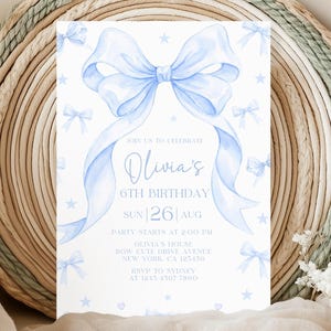 May include: A pale blue birthday invitation with a watercolour bow design and additional small bows. The invitation text reads "Olivia's 6th Birthday" with event details. The design includes stars and hearts, suitable for a child's celebration.