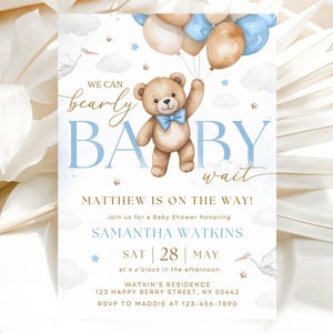 May include: A blue and white baby shower invitation with a teddy bear holding balloons. The invitation says "We can bearly wait" and "Matthew is on the way!"  Join us for a Baby Shower honouring Samantha Watkins.  Sat | 28 | May at 4 o'clock in the afternoon.  Watkin's Residence 123 Happy Berry Street, NY 50442 RSVP to Maddie at 123-456-7890