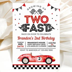 May include: A birthday invitation with a race car theme. The design features the words "TWO FAST" in red and black, flames, checkered flags, and a red race car. The invitation includes the birthday details: date, time, and location.