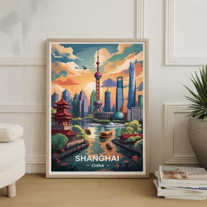 May include: A framed art print featuring a colorful illustration of Shanghai, China. The artwork depicts the city's skyline with iconic buildings, a river with boats, and a vibrant sunset. The text "SHANGHAI - CHINA" is displayed at the bottom.