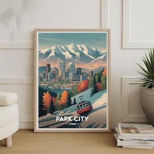 Pode incluir: Uma impressão artística emoldurada com uma ilustração estilizada de Park City, Utah. A obra de arte retrata uma paisagem urbana com montanhas cobertas de neve ao fundo, um teleférico vermelho e o texto "PARK CITY - UTAH". A paleta de cores inclui azuis, verdes, vermelhos e castanhos.