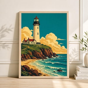 May include: A framed art print of a coastal scene featuring a white lighthouse with a red roof and a small building. The artwork depicts a sandy beach, ocean waves, and a blue sky with fluffy clouds. The lighthouse is on a cliff.