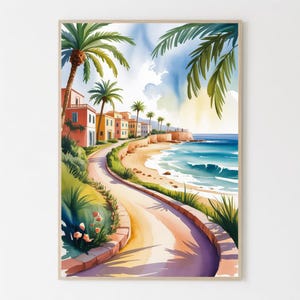 May include: Watercolor painting of a coastal scene with a winding road, buildings, palm trees, and the ocean. The artwork features a warm color palette with shades of pink, yellow, and blue. The artwork is framed in a light-colored wooden frame.
