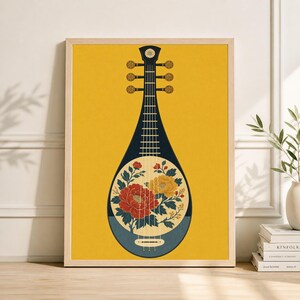 May include: A framed print featuring a stylized pipa, a traditional Chinese stringed instrument. The instrument is dark blue with a yellow background. The sound hole is filled with red and yellow flowers. The frame is light brown.