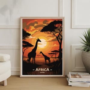 May include: Framed art print depicting an African sunset with silhouetted giraffes and trees. The sky is a blend of orange and yellow hues. The text "AFRICA - SAFARI" is printed at the bottom of the artwork.