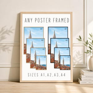 May include: Framed posters in various sizes, including A1, A2, A3, and A4, are displayed. The posters feature a scenic view of a tall white tower against a blue sky and red rooftops. The text "ANY POSTER FRAMED" and "SIZES A1, A2, A3, A4" are visible.