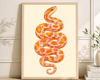 May include: A framed print featuring a detailed illustration of a snake. The snake is depicted in shades of orange, yellow, and pink, with a patterned design. The artwork is set against a cream-colored background, and framed in a light wood.