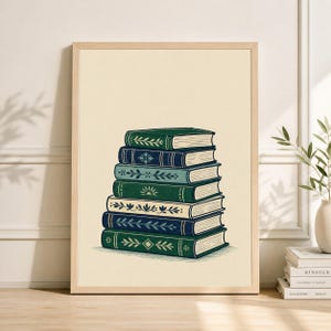 May include: A framed print featuring a stack of seven books. The books have green, blue, and cream-colored covers with decorative floral and geometric designs. The artwork is set against a cream background, with a wooden frame.