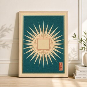 May include: Framed art print featuring a stylized sunburst design with a central square. The artwork has a teal background with a textured appearance, and the sunburst is rendered in shades of beige and red. Japanese text is in the lower right corner.