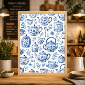 May include: A framed print with a repeating pattern of blue and white teapots, cups, and floral elements. The watercolour design includes teacups, saucers, sugar bowls, and spoons. The artwork is set against a white background.