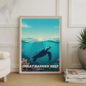 May include: Framed art print featuring a stylized illustration of a sea turtle swimming underwater. The artwork depicts the Great Barrier Reef with the text "GREAT BARRIER REEF - AUSTRALIA" in a wooden frame. The color palette includes shades of blue, green, and orange.