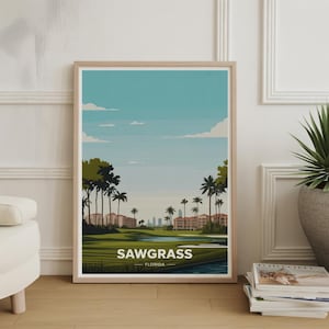 May include: A framed art print featuring a stylized landscape of Sawgrass, Florida. The artwork depicts a golf course with palm trees, buildings, and a body of water under a blue sky with clouds. The text "SAWGRASS FLORIDA" is displayed at the bottom.