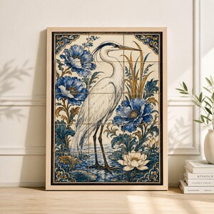 May include: A framed artwork featuring a white heron standing in water, surrounded by blue floral elements and foliage. The artwork is composed of multiple tiles, with a light wood frame. The color palette includes shades of blue, white, and gold.