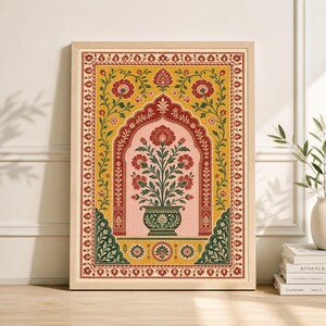 May include: A framed art print featuring a floral design in a traditional style. The artwork showcases a vase of red flowers within an archway, set against a yellow and pink background, with a decorative border.