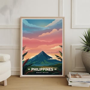 May include: A framed art print featuring a stylized landscape of Mount Mayon in the Philippines. The artwork showcases a vibrant sunset with pink and orange hues, a blue mountain, and the text "PHILIPPINES" and "MOUNT MAYON".