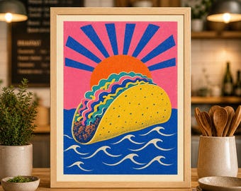 May include: A framed print featuring a colorful illustration of a taco with a sunset background. The taco is yellow with a detailed filling, set against a pink sky with blue sun rays. Blue waves complete the design.
