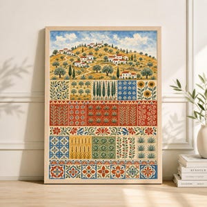 May include: A framed art print depicting a hillside village with white buildings and olive trees under a blue sky. The lower section showcases a series of colourful, patterned panels with floral and geometric designs. The artwork is presented in a wooden frame.