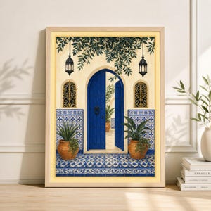 May include: Framed art print depicting a courtyard scene. A vibrant blue door is open, revealing a glimpse of a sunlit interior. The scene includes potted plants, ornate tilework, and hanging lanterns, creating a Mediterranean aesthetic.