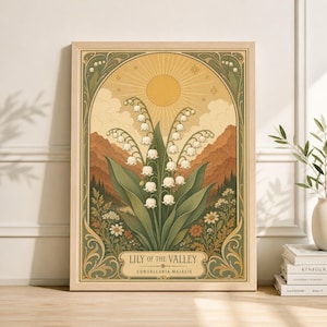May include: A framed art print with a botanical illustration of Lily of the Valley. The artwork depicts white bell-shaped flowers with green leaves, set against a backdrop of a sun, mountains, and a decorative border. The text "LILY OF THE VALLEY" is displayed at the bottom of the print.