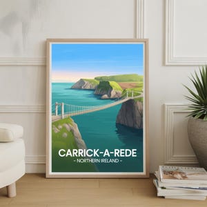 May include: A framed print showcasing the Carrick-a-Rede rope bridge in Northern Ireland. The image features a suspension bridge over the sea, with green cliffs and a blue sky. The text "CARRICK-A-REDE - NORTHERN IRELAND -" is displayed at the bottom of the print.