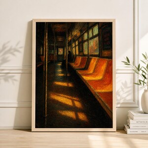 May include: A framed art print depicting the interior of a subway car. The artwork features orange seating, windows, and a figure in the distance. Sunlight streams through the windows, casting shadows on the floor. The overall color palette is warm and inviting.