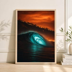May include: A framed print featuring a dramatic ocean wave. The wave is a vibrant turquoise, illuminated against a dark, moody background. The sky is a fiery orange, and the image is framed in a light wood.
