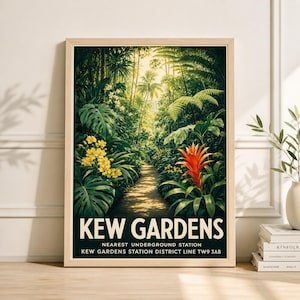 May include: A framed print of Kew Gardens, featuring a lush, green pathway through a tropical garden. The artwork showcases vibrant yellow and red flowers, with the text "KEW GARDENS" at the bottom. The print is in a light-colored wooden frame.