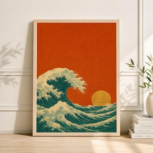May include: Framed art print featuring a stylized depiction of a large ocean wave with a cresting white foam, set against a vibrant orange background with a golden sun. The artwork is in a wooden frame.
