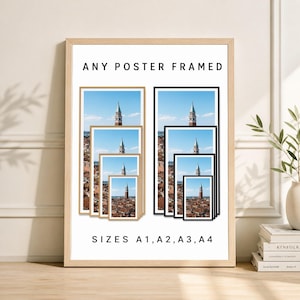May include: Framed posters in various sizes, including A1, A2, A3, and A4, are displayed. The posters feature a scenic view of a tall tower against a blue sky. The text "ANY POSTER FRAMED" and "SIZES A1, A2, A3, A4" are visible.