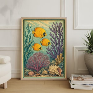 May include: Framed art print featuring an underwater scene with three yellow fish, coral, and seaweed. The artwork has a vintage style with a light wood frame and a green border. Seashells and a starfish are at the bottom of the image.