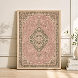 May include: A framed print of a vintage-style rug. The rug features a central diamond pattern in olive green and cream, set against a dusty rose background. The frame is a light wood color, and the overall design evokes a classic, timeless aesthetic.