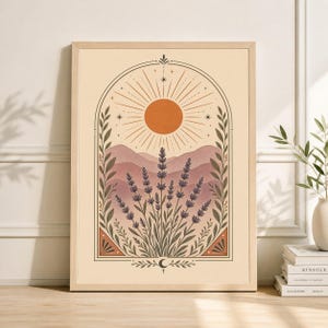 May include: A framed art print featuring a stylized landscape with a warm color palette. The artwork depicts a sun, mountains, and lavender plants within an arched frame. The print has a light wood frame and is displayed on a light-colored wall.