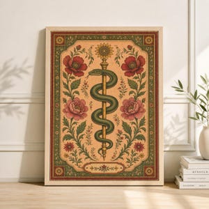 May include: A framed art print depicting a green serpent entwined around a golden staff, crowned with a sunflower. The artwork is set against a tan backdrop with red and pink floral elements and a decorative border. The frame is light brown.