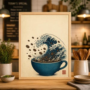 May include: A framed art print featuring a blue coffee cup with coffee beans and a wave design. The wave is depicted in shades of blue and white, with coffee beans floating above the cup. The print has a light brown background and a wooden frame.