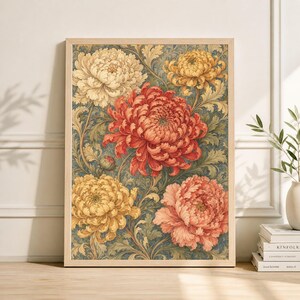 May include: A framed floral print featuring large, detailed chrysanthemum blooms in shades of yellow, peach, and red. The flowers are set against a backdrop of blue-green foliage. The wooden frame adds a natural touch to the artwork.