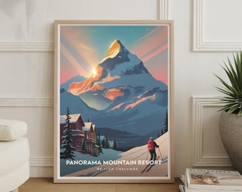 May include: Framed art print featuring a mountain scene with a skier and the text "Panorama Mountain Resort, British Coalumba." The artwork depicts a snow-covered mountain with a sunset in the background. Red and brown buildings are visible at the base of the mountain.