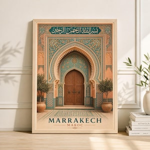 May include: A framed print featuring a detailed illustration of a Moroccan archway and door. The archway is adorned with teal and gold mosaic tiles, with the text "Marrakech Maroc" at the bottom. Two potted trees flank the entrance.