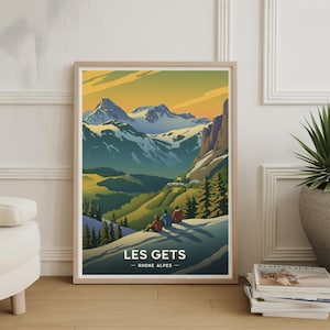 May include: A framed vintage travel poster for Les Gets, Rhône-Alpes, showcasing a mountain landscape. The artwork features snow-covered peaks, green valleys, and three figures seated on a hillside, with text at the bottom.