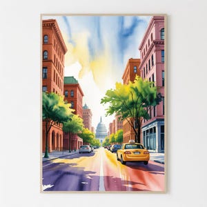 Puede incluir: Impresión en acuarela de una escena de calle urbana con edificios, árboles y un taxi amarillo. La obra presenta una vista por una calle hacia un edificio con cúpula, con un cielo colorido y edificios en tonos rojos, rosas y naranjas.