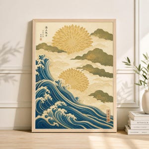 May include: Framed art print featuring a Japanese-inspired design. The artwork depicts stylized ocean waves in shades of blue, with two large yellow floral shapes and cloud-like forms in the background. The print includes Japanese text and is set in a light wood frame.