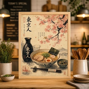 May include: Framed print of a Japanese ramen bowl with cherry blossoms. The image features a bowl of ramen with pork, seaweed, and an egg, alongside a sake bottle and chopsticks. The text "Tokyo" is visible.