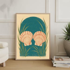 May include: A framed art print depicting two peach and white scallop shells, set against a teal archway and green grass-like elements. The background is a light beige colour, and the artwork is in a wooden frame.
