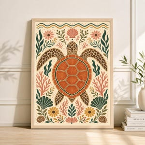 May include: A framed art print featuring a sea turtle illustration. The turtle is orange with a brown shell and is surrounded by coral, flowers, and seashells in shades of pink, green, and yellow. The background is a light beige.